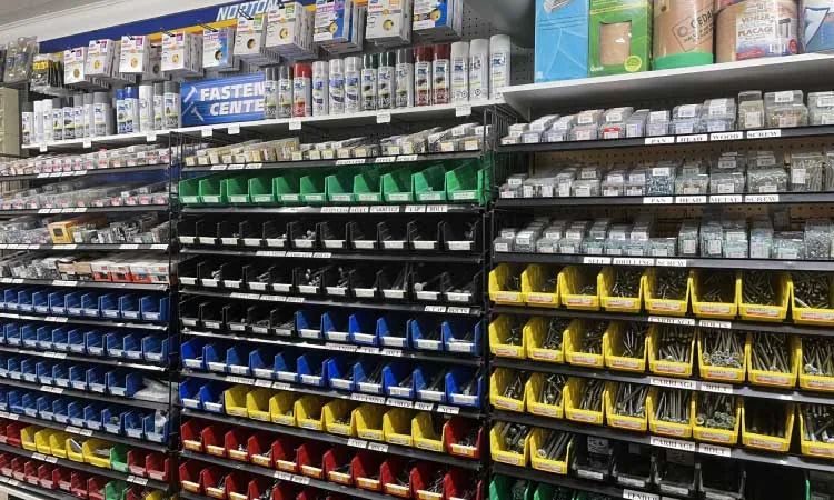 In-store fastener aisle stocked with bins of hardware