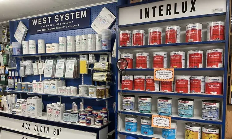 Shelves of West System epoxy and Interlux marine paints in store